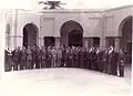 صورة تذكارية لوفد من مجلس النواب السوري مع الملك فيصل الثاني ملك العراق في بغداد سنة 1956. الثامن من اليمين: دولة الرئيس معروف الدواليبي نائب حلب عن حزب الشعب ورئيس الحكومة السورية الاسبق - غير معروف - الدكتور عدنان الاتاسي نائب حمص وسفير سورية الأسبق في فرنسا - الأمير عبد الإله الوصي على عرش العراق - نائب حمص ووزير الخارجية الأسبق فيضي الأتاسي - جلالة الملك فيصل الثاني ملك العراق - نائب حلب إحسان الجابري - نائب حماة وأحد زعماء حزب البعث العربي الاشتراكي وزير الدفاع الأسبق أكرم الحوراني - نائب رئيس مجلس النواب الأسبق ونائب دير الزور محمد بك العايش - نائب دمشق ورئيس الحزب التعاوني الاشتراكي فيصل العسلي - غير معروف - غير معروف - غير معروف - غير معروف - نائب دمشق وأحد مؤسسي حزب البعث الدكتور صلاح البيطار.