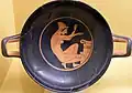 Woman kneeling before an altar. Attic red-figure kylix, 5th BC