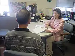 A Probation and Parole Officer with the Missouri Department of Corrections interviews a drug-related offense probationer