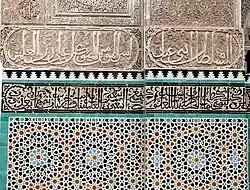 مثال على الزخارف الهندسية في الزليج (أدناه) والخط العربي في البلاط والجص المنقوش (أعلاه) في المدرسة البوعنانية