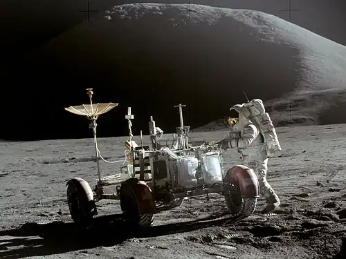 Astronaut works on the Moon at the lunar rover