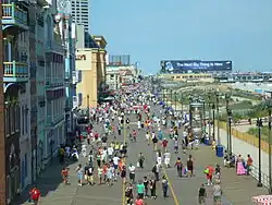 Many people walking on a boardwalk at the beach in Atlantic City, New Jersey