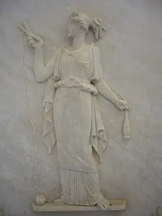 أتروبوس cutting the thread of life. Ancient Greek low relief.