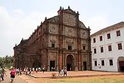 A church in red brick and an adjacent building in white