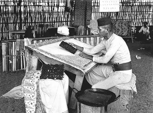 An Arab Indonesian working on باتيك wax stamps to work in Tanah Abang
