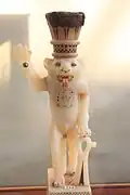 أنية لحفظ الدهان على شكل المعبود بس، رب المرح والموسيقى، الدولة الحديثة، توت عنخ آمون، 1336- 1327 ق.م.