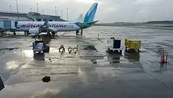 Caribbean Airlines Boeing 737-800 with a ride range of Airport ground support equipment