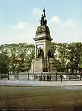 Dutch Maiden atop the national monument at Plein 1813 in The Hague. From a postcard dating around 1890-1905.