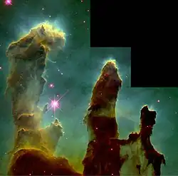 Three pillars of opaque gas stand tall in a green nebulous background