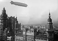 The أل زد 127 غراف زبلن flying over the building in 1934.