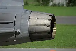 Side-view of circular aircraft engine exhaust nozzle, showing two distinct layers.