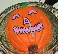 A Halloween cake prepared with the appearance of a jack-o'-lantern