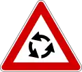 Italy and Latvia roundabout ahead sign.