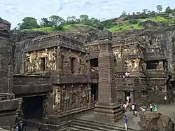 Tourists visiting a temple cut in rock
