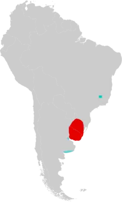 Map of South America marked by red and blue colors, with the red color extending over Uruguay and into Rio Grande do Sul, southern Brazil, and the blue color in southeastern Minas Gerais, eastern Brazil, and in two different areas in northern and southern Buenos Aires Province, eastern Argentina.