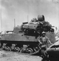 A captured Type 94 tankette with a damaged turret, on the engine deck of a USMC إم 4 شيرمان tank at Kwajalein