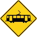 Caltrans light rail crossing ahead sign.