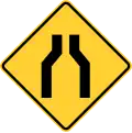 Canada New York State one lane road ahead sign.