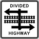 U.S. rail line in highway median of cross street.