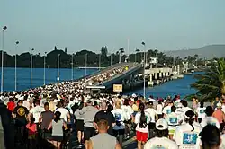Hundreds of runners at the start line of a marathon at the O'ahu side of the Admiral Clarey bridge.
