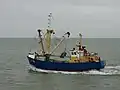 Fishing vessel equipped with a benthic dredge, leaving the port of Nieuwpoort