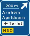K2: Advance warning sign of a motorway showing the distance to the next exit and destinations after the exit (the top destination is the name of the exit), direction to aerodrome/airport and the road number (non-motorway)
