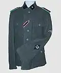 M43 field tunic – SD Unterscharführer with SS rank insignia on the collar patch, and police rank insignia (Wachtmeister) on the shoulder straps and SD diamond on lower part of sleeve