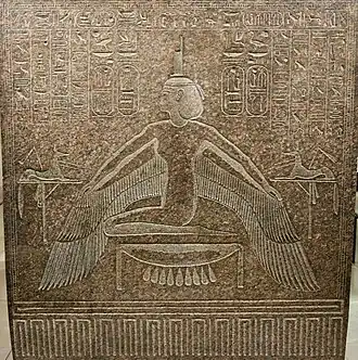 Relief of a woman kneeling on a stool and spreading her arms, to which wings are attached