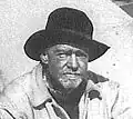 Bearded middle-aged man with a cowboy hat.