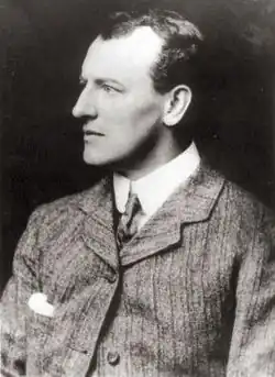 Young man in a suit, looking left