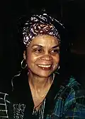  Black woman with head covering, close up, smiling and looking to the right