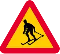 Sweden skiers crossing sign.