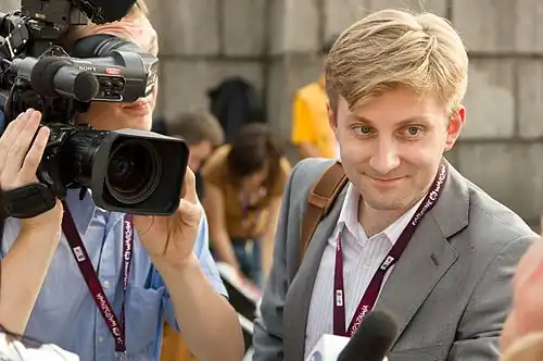 A camera person filming a fan with Krzysztof Bandych, Polish journalist (nSport channel) in Warsaw, just after the end of Poland-Greece match. UEFA Euro 2012, Poland.