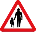U.K. pedestrians on road ahead sign.