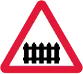 U.K. level crossing with gate or barrier sign.