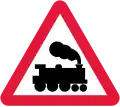 Railway level crossing without gate or barrier ahead.