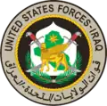 شارة القماش القتالية (Combat patch) لقوات الولايات المتحدة - العراق (القوات الأمريكية في العراق): يهدف سعف النخيل إلى تمثيل السلام والازدهار، تحت الثور المجنح