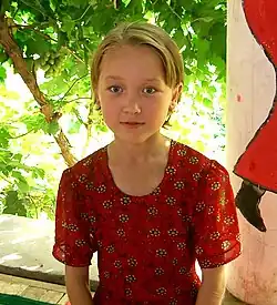 A girl looks at the camera.