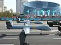 طائرة تشنغدو وينغ لونغ عسكرية أثناء مسيرة يوم المدافع عن الوطن&nbsp;[الإنجليزية] في ميدان الاستقلال فيآستانا.